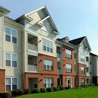 Exterior view of Avalon Rothbury, an occupied multifamily apartment complex with 100+ units—renovated with upgraded siding, brick façade, and modern balcony features.
